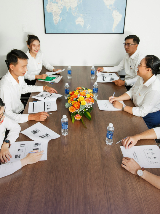 Team reviewing documents at a conference table during a client engagement