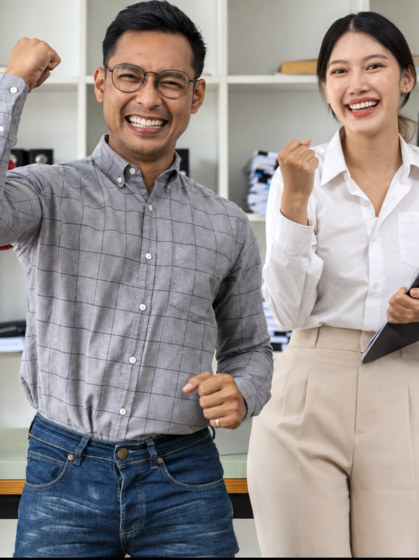 Two colleagues celebrating a project win in the office